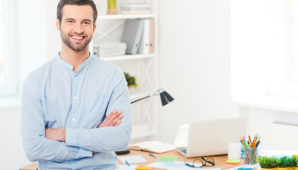 Male teacher by a computer