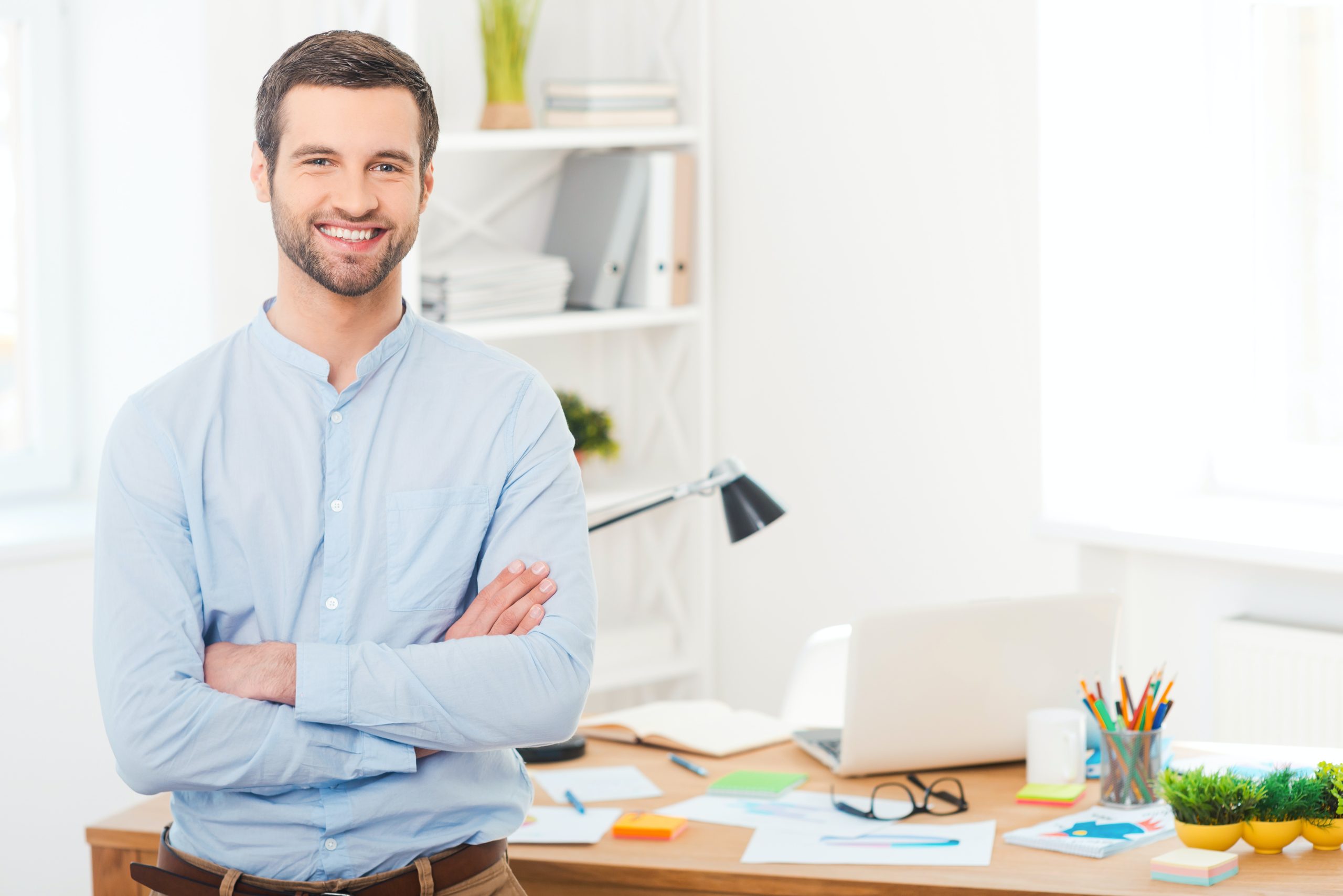 Male teacher by a computer