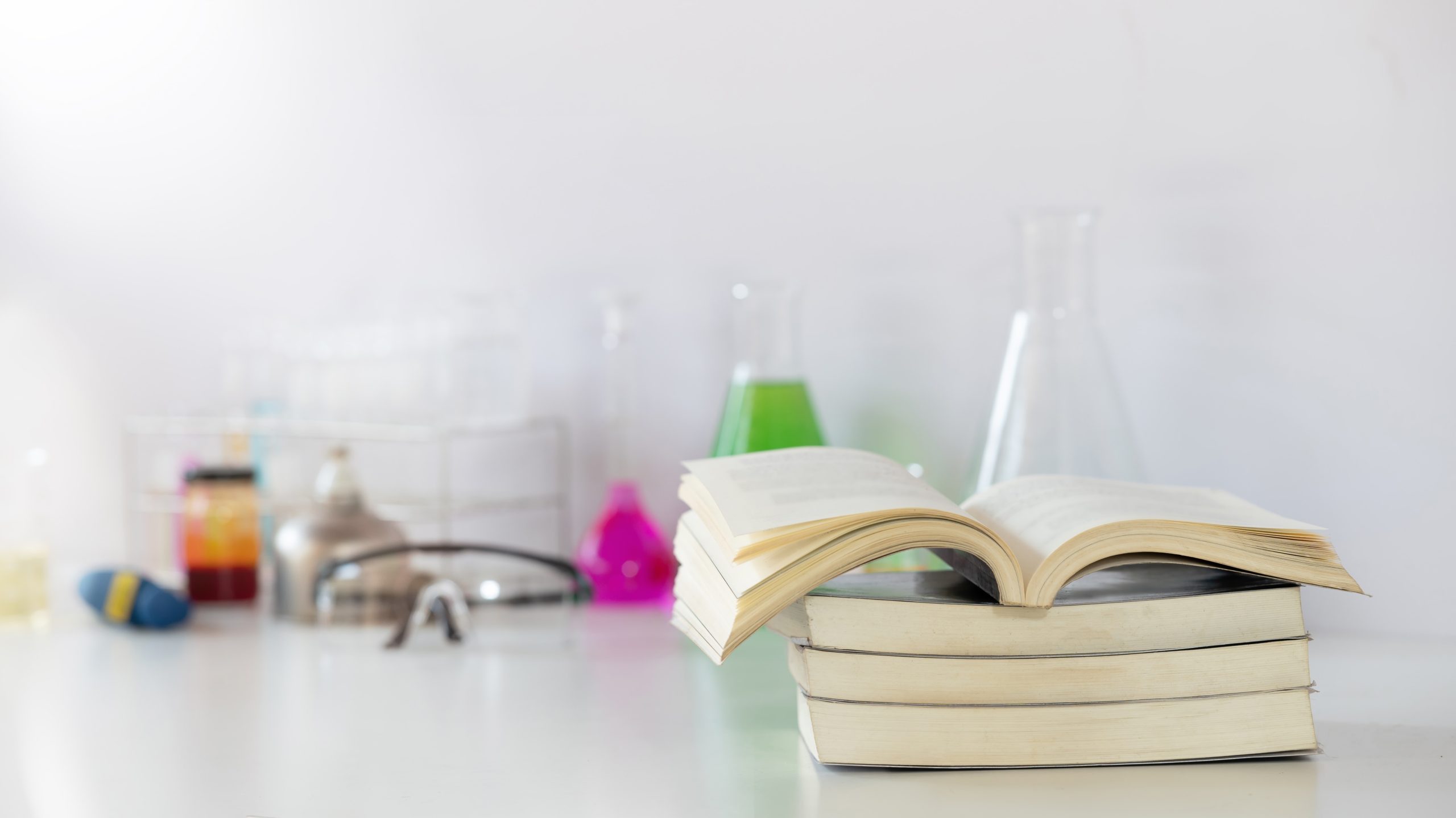 Books in front of chemistry flasks