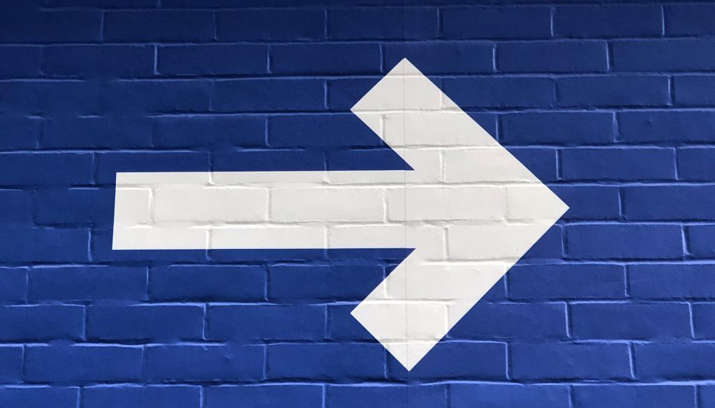 White arrow on blue background