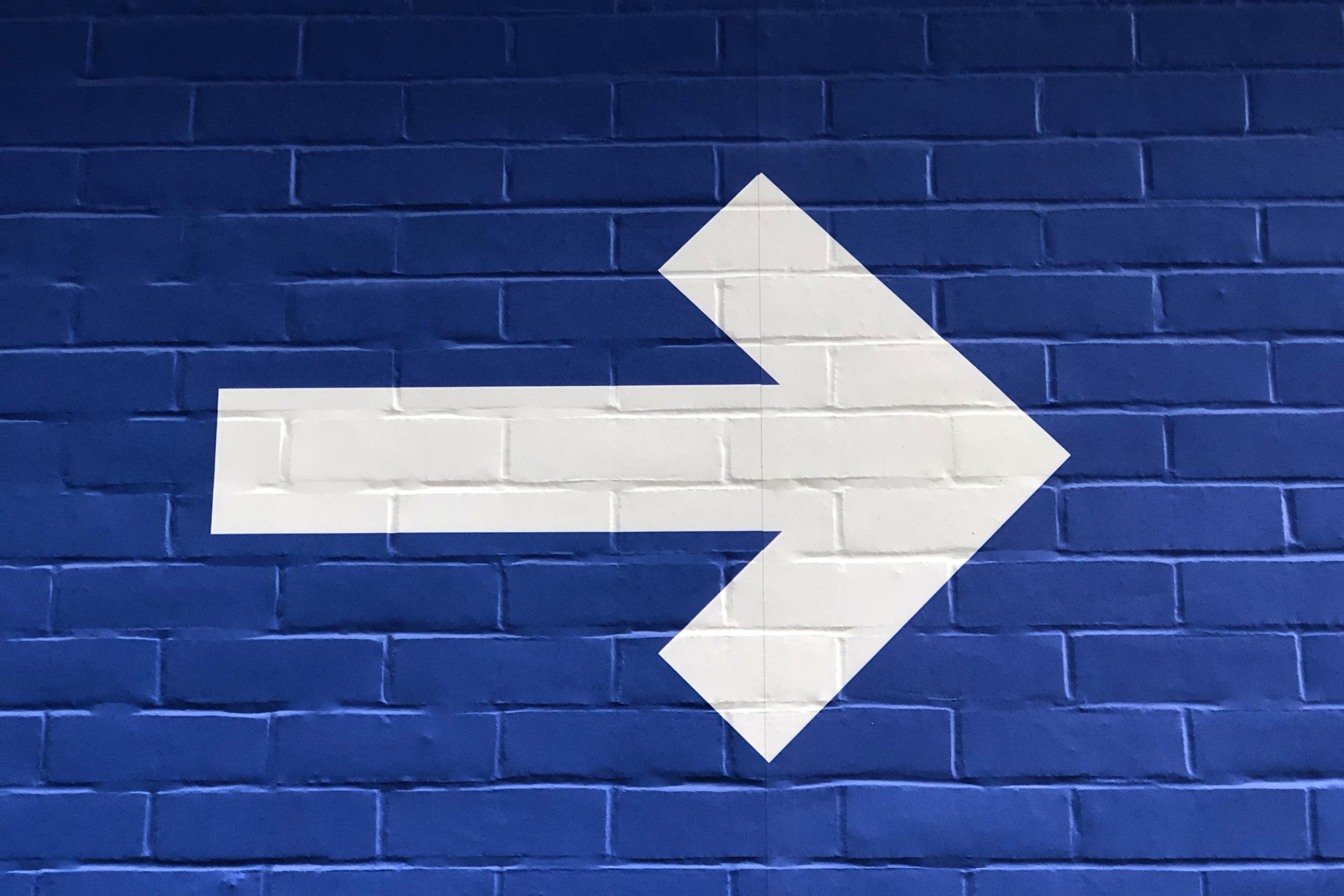 White arrow on blue background