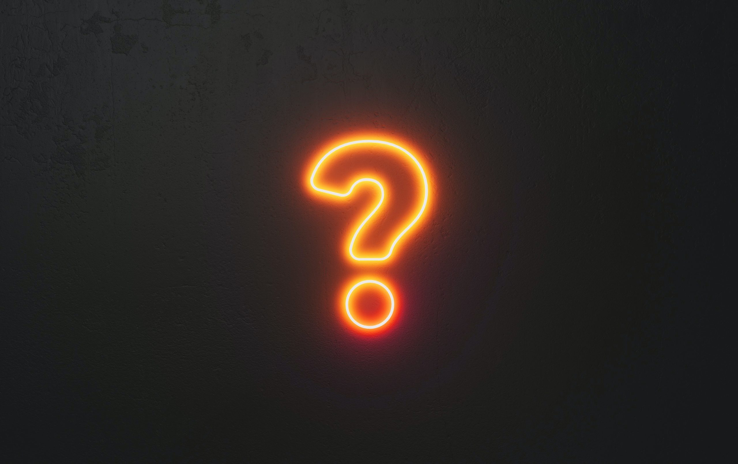 Orange neon question mark sign against black wall