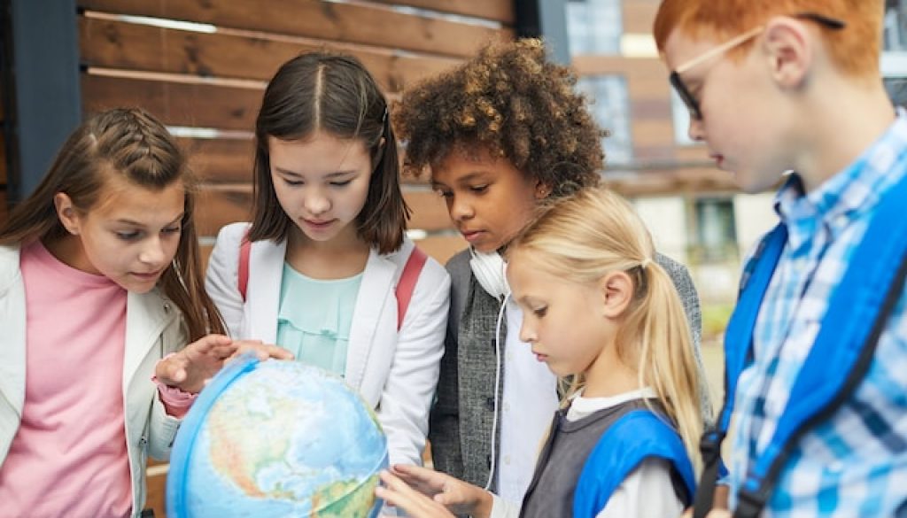 Children exploring a globe