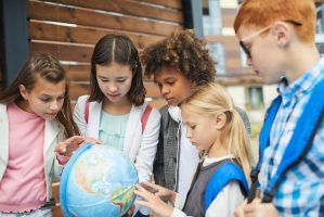 Children exploring a globe