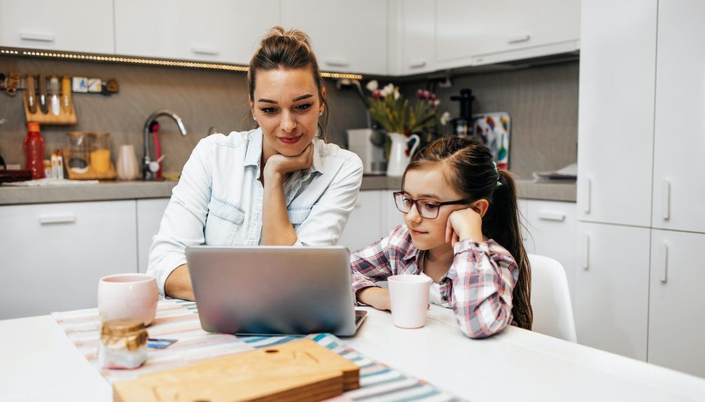 woman and pre-teen during online instruction