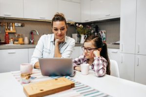 woman and pre-teen during online instruction