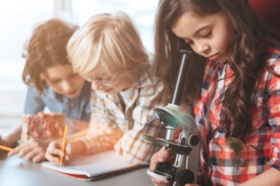 children using a microscope