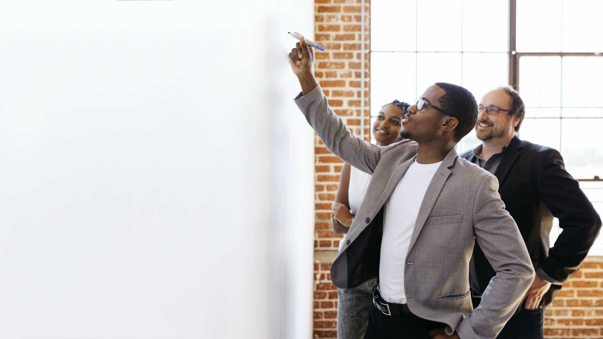 Man writing on dry erase board