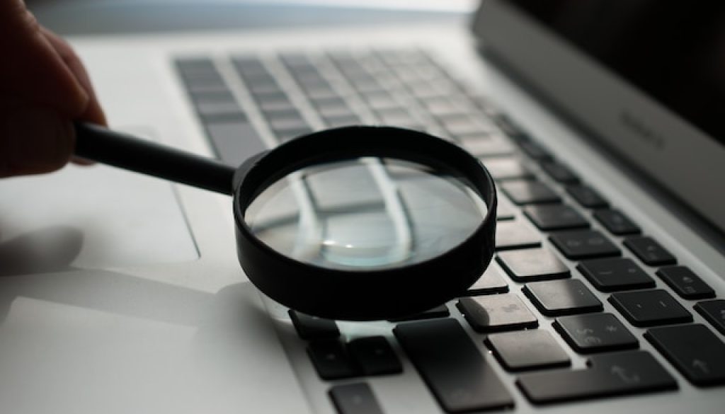 magnifying glass on laptop keyboard