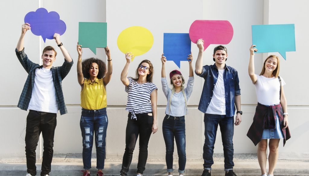 Young adult friends holding up copyspace placard thought bubbles