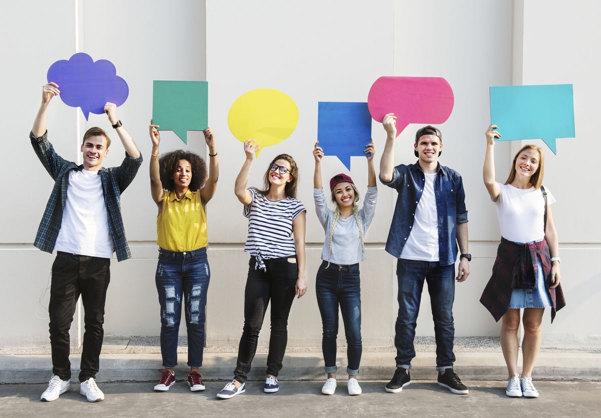 Young adult friends holding up copyspace placard thought bubbles