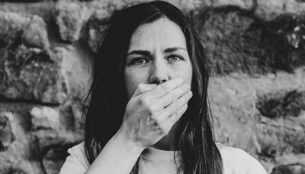 woman covering mouth with hand