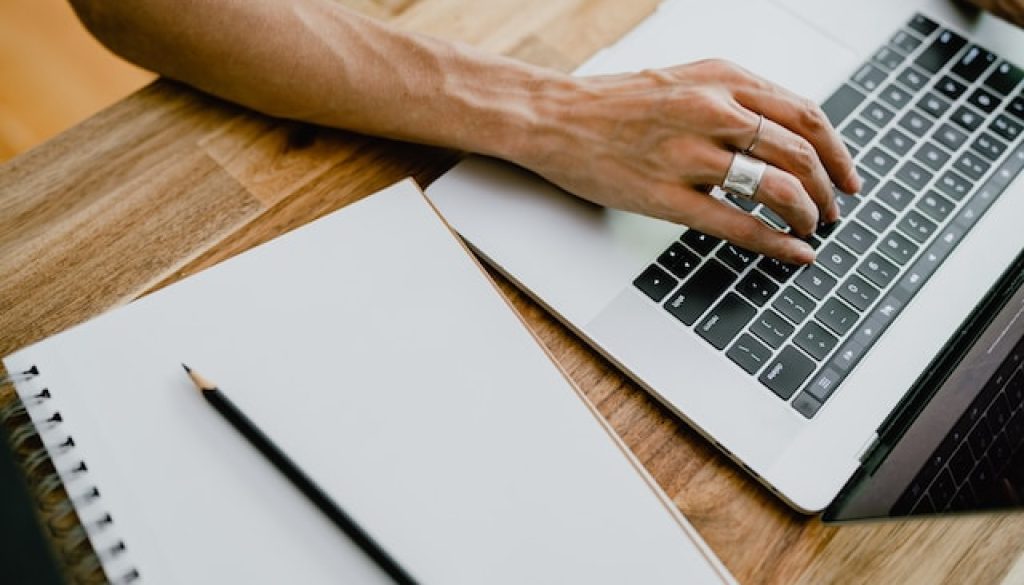 person typing on a laptop keyboard