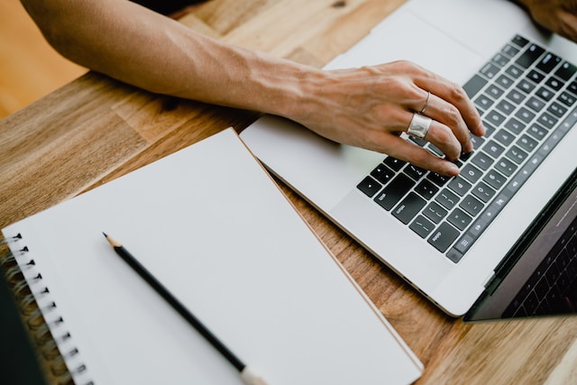 person typing on a laptop keyboard